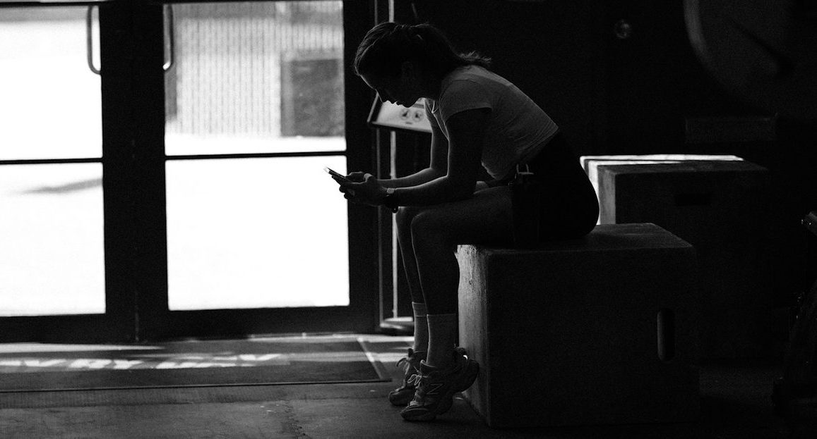 Athlete sitting quietly in the gym after training